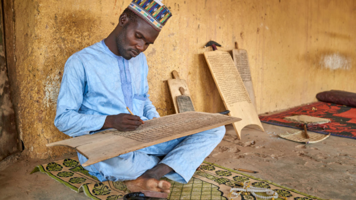 A Muslim Man Practicing Quaranic Calligraphy on a Wooden Board in Katsina, Northern Nigeria - 2019
